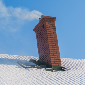 masonry chimney on a snowy roof