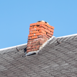 a red brick chimney that's crumbling